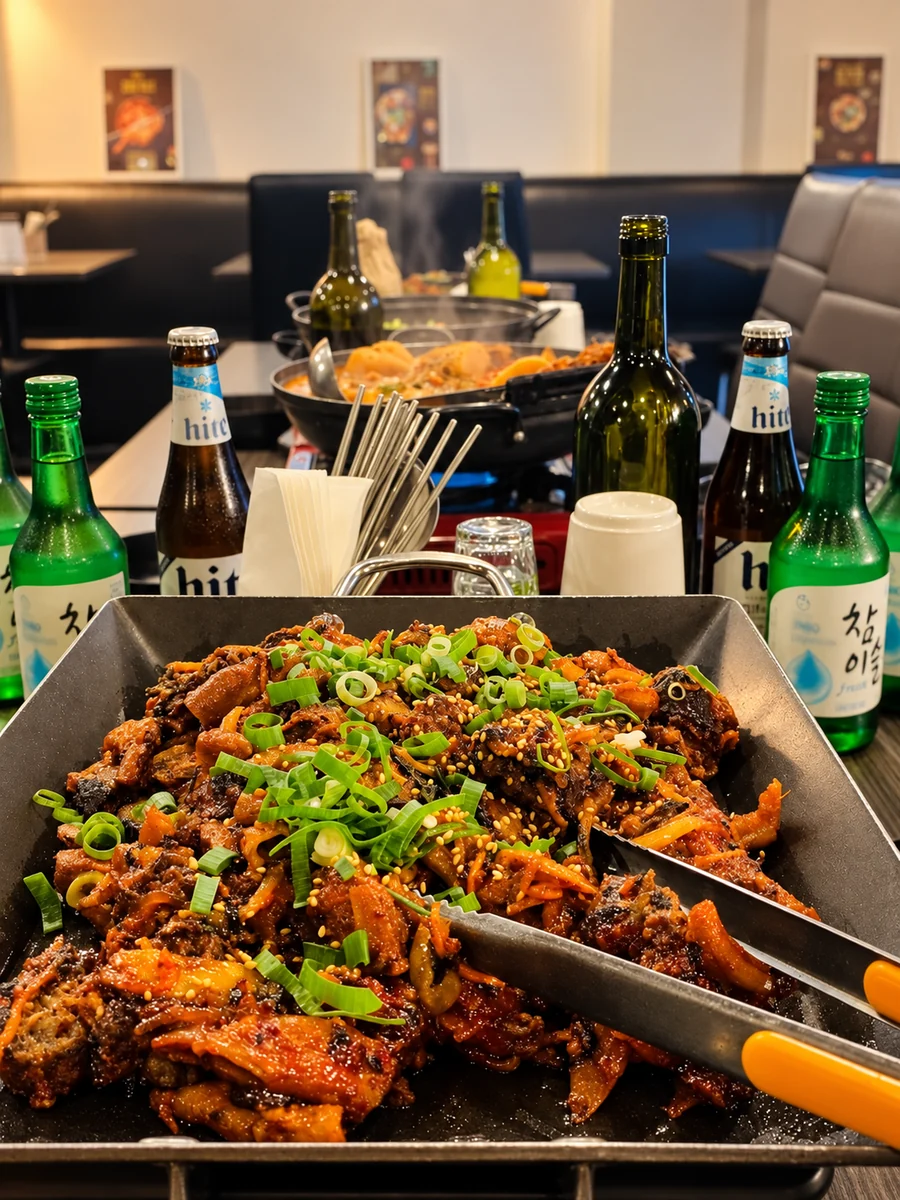 A Korean sharing platter surrounded by soju and beer bottles